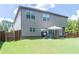 Backyard featuring a patio with an outdoor dining set, lush green lawn and wood fence at 15 Blanket Pass, Covington, GA 30016