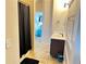 This bathroom features a vanity with dark wood cabinets and a tiled floor at 15 Blanket Pass, Covington, GA 30016