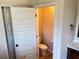 Bathroom featuring a toilet and sink with dark wood cabinetry at 15 Blanket Pass, Covington, GA 30016