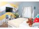 Bright bedroom featuring stylish painted accent wall, desk, and cozy furniture at 15 Blanket Pass, Covington, GA 30016