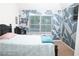 Bedroom with grey/white/blue design wall, blinds, bed, and flat screen tv at 15 Blanket Pass, Covington, GA 30016