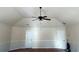 Carpeted bonus room featuring a vaulted ceiling, ceiling fan, and two entry doors at 15 Blanket Pass, Covington, GA 30016