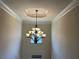 Elegant foyer features a modern chandelier and trim at 15 Blanket Pass, Covington, GA 30016