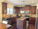 Kitchen with island, dark cabinets, and stainless appliances at 15 Blanket Pass, Covington, GA 30016