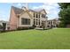 Spacious backyard with well-manicured lawn, patio and large windows to the home at 2571 Weddington Ne Rdg, Marietta, GA 30068