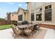 Backyard patio with a dining table, grill, and well-maintained landscaping at 2571 Weddington Ne Rdg, Marietta, GA 30068