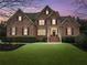Charming two-story brick home with manicured lawn and mature landscaping at 2571 Weddington Ne Rdg, Marietta, GA 30068