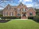 Beautiful two-story brick home featuring a well-manicured lawn and welcoming front porch at 2571 Weddington Ne Rdg, Marietta, GA 30068