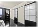 Hallway features black framed sliding barn doors and adjacent dark accent wall at 2571 Weddington Ne Rdg, Marietta, GA 30068