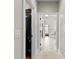 Hallway leading to a bright bathroom with tiled floors and a shower over the bathtub at 2571 Weddington Ne Rdg, Marietta, GA 30068