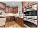 Close-up of gourmet kitchen with stainless-steel appliances and rich wood cabinetry at 2571 Weddington Ne Rdg, Marietta, GA 30068