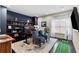 Home office with built-in shelving, blue accent wall, and natural light from a window at 2571 Weddington Ne Rdg, Marietta, GA 30068