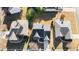 Aerial view of rooftops and well-kept lawns of homes with a gray roof and long driveways at 3125 Crooked Stick Dr, Cumming, GA 30041