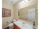 Bright bathroom featuring a sleek vanity, a toilet, framed art and a large mirror with modern decor at 3125 Crooked Stick Dr, Cumming, GA 30041