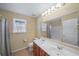 Well-lit bathroom with double sink vanity and large mirror at 3125 Crooked Stick Dr, Cumming, GA 30041