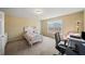 Bright bedroom with a twin bed, a bedside table, a modern desk, and a window with a view at 3125 Crooked Stick Dr, Cumming, GA 30041