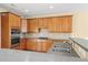 Well-equipped kitchen with stainless oven, wood cabinets, and breakfast bar at 3125 Crooked Stick Dr, Cumming, GA 30041