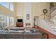 Spacious living area featuring a fireplace, hardwood floors, and ample natural light, perfect for relaxation at 3125 Crooked Stick Dr, Cumming, GA 30041