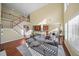 Bright living room features vaulted ceiling, hardwood floors, and staircase to second floor at 3125 Crooked Stick Dr, Cumming, GA 30041