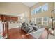 Sunlit living room boasts hardwood floors, a large window, and comfortable seating at 3125 Crooked Stick Dr, Cumming, GA 30041
