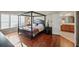 Main bedroom with a four-poster bed, hardwood floors, and lots of natural light at 3125 Crooked Stick Dr, Cumming, GA 30041