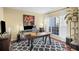 Stylish office space with a modern desk setup, cozy rug, and bright natural light, ideal for productivity at 3125 Crooked Stick Dr, Cumming, GA 30041