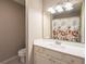 Neutral bathroom with a large mirror, single vanity, and a shower/tub combo at 14 Muncy Se Ct, Smyrna, GA 30080