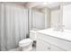 Bright bathroom featuring a large vanity, toilet, mirror and tub with light gray shower curtain at 14 Muncy Se Ct, Smyrna, GA 30080