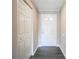 Hallway features a closet, contrasting grey plank flooring, and a well-lit entryway with a front door at 14 Muncy Se Ct, Smyrna, GA 30080