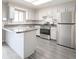 Bright kitchen with stainless steel appliances, grey countertop, and grey wood-look flooring at 14 Muncy Se Ct, Smyrna, GA 30080