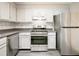 An inviting kitchen with stainless steel appliances, grey countertops, and white cabinets at 14 Muncy Se Ct, Smyrna, GA 30080
