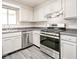 The kitchen features stainless steel appliances, white cabinetry, and a grey countertop at 14 Muncy Se Ct, Smyrna, GA 30080