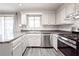 The kitchen features stainless steel appliances, grey countertops, and white cabinets at 14 Muncy Se Ct, Smyrna, GA 30080