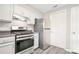 The kitchen features stainless steel appliances, white cabinetry, and a grey countertop at 14 Muncy Se Ct, Smyrna, GA 30080