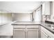 Open floor plan with kitchen island, stainless steel sink, and living room with mirrors at 14 Muncy Se Ct, Smyrna, GA 30080
