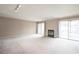Expansive living room featuring a fireplace, sliding glass doors to a balcony, and neutral carpeting throughout at 14 Muncy Se Ct, Smyrna, GA 30080
