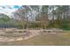 Outdoor stone bench seating area with a pergola, stepping stone path, and some grass at 14 Muncy Se Ct, Smyrna, GA 30080