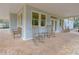 Covered patio with classic rocking chairs on a brick floor, perfect for relaxing outdoors at 14 Muncy Se Ct, Smyrna, GA 30080