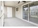 Spacious covered porch featuring a storage closet, large sliding doors, and neutral colors at 14 Muncy Se Ct, Smyrna, GA 30080