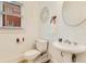 Powder room with white fixtures, round mirror, and decorative accents at 1408 Aramore Dr, Conyers, GA 30013