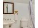 Bathroom with pedestal sink, wooden accents, and neutral finishes at 1408 Aramore Dr, Conyers, GA 30013
