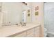 Bright bathroom featuring a white vanity, large mirror, and tiled shower at 1408 Aramore Dr, Conyers, GA 30013