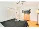 A neutral bedroom features a closet, television, and light-colored hardwood floors at 1408 Aramore Dr, Conyers, GA 30013
