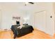 A bedroom shows a double closet, bedside table, and light-colored hardwood flooring at 1408 Aramore Dr, Conyers, GA 30013