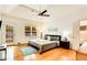 Cozy main bedroom boasts hardwood floors, a ceiling fan, and access to the bathroom and backyard at 1408 Aramore Dr, Conyers, GA 30013