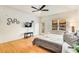 A bedroom features a ceiling fan, television, and bright, neutral walls and floors at 1408 Aramore Dr, Conyers, GA 30013