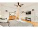 A staged bedroom shows a bed with gray linens, hardwood floors, and neutral walls at 1408 Aramore Dr, Conyers, GA 30013