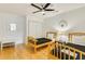 Bright bedroom featuring two beds, hardwood floors, and a ceiling fan at 1408 Aramore Dr, Conyers, GA 30013