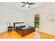 A bedroom shows a bedside table and a dark-wood frame bed near a window at 1408 Aramore Dr, Conyers, GA 30013
