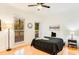 A bright bedroom is staged with an end table and floor lamp near a window at 1408 Aramore Dr, Conyers, GA 30013